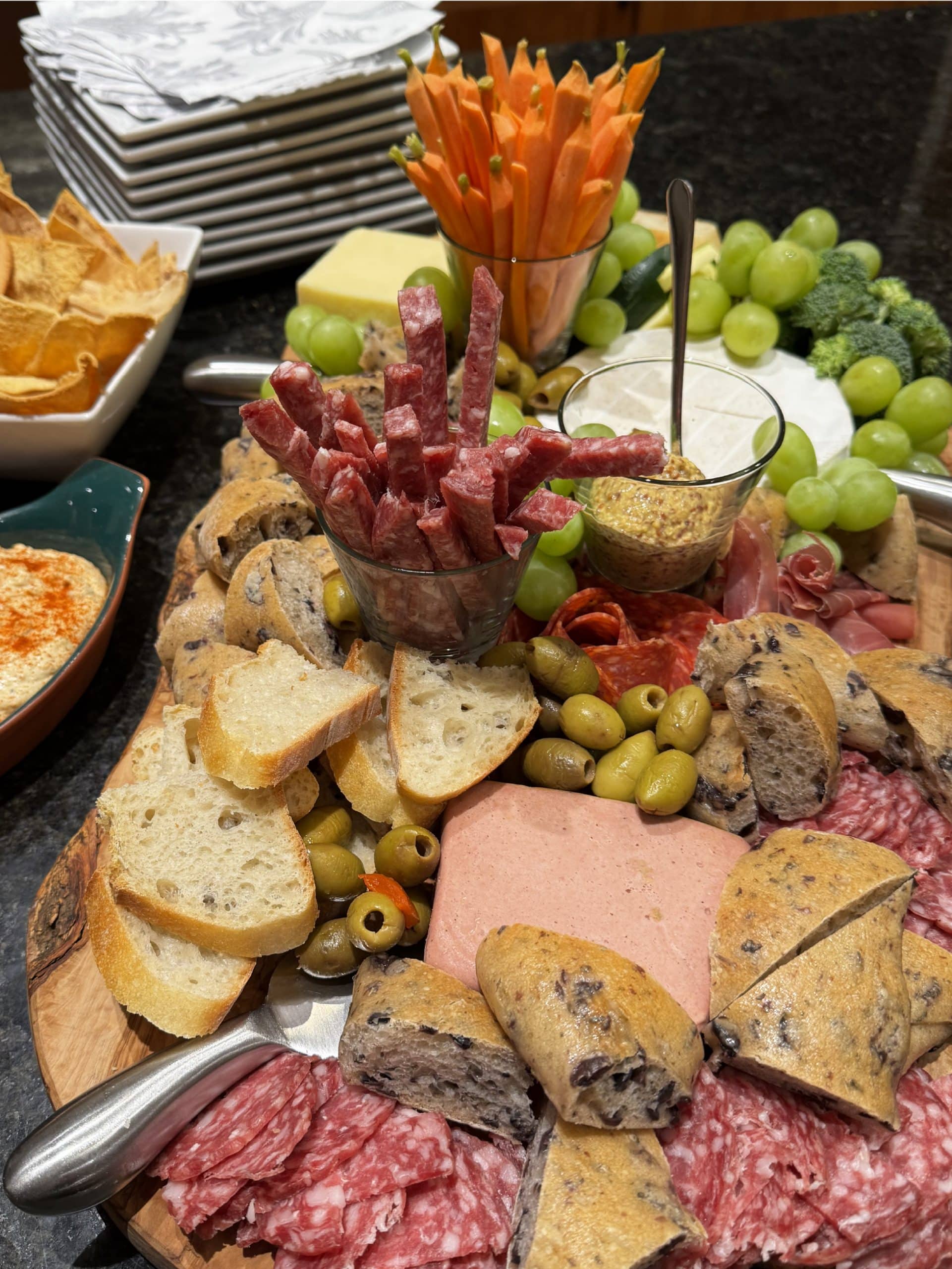 Mixed Charcuterie and cheese board for 10 people served with hummus and grilled pita chips